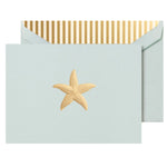 The Gold Starfish Classic Card Set by Crane features a gold starfish design on light blue Beach Glass paper, paired with envelopes lined in gold and white vertical stripes.