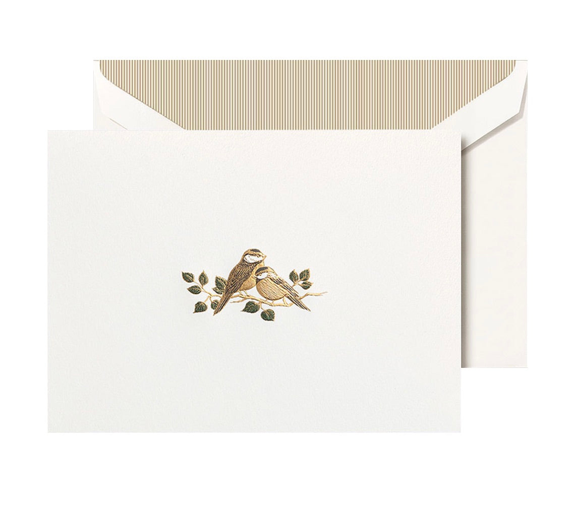 The Crane Love Bird Card Set features pearl white folded notes with two brown birds on branches, paired with matching envelopes and striped liners—crafted from premium cotton paper.