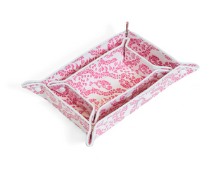 The Luxe Gloss All Heart Travel Set in Kelly Pink by TRVL Design features a rectangular pink tray with heart motifs, raised sides, and folded, buttoned corners—ideal for travel accessories. A smaller matching tray nests inside.