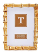 The Bamboo Natural Frame Collection by Two's Company features a timeless rectangular 5x7" photo frame with an eco-friendly bamboo-style design, a gold finish, and a "T" placeholder insert.