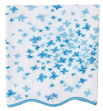 The Betty Floral Scallop Towel Collection by Weezie Towels features a square white quick-dry towel with a blue floral pattern and light blue wavy trim, combining elegance and function for your bath routine.