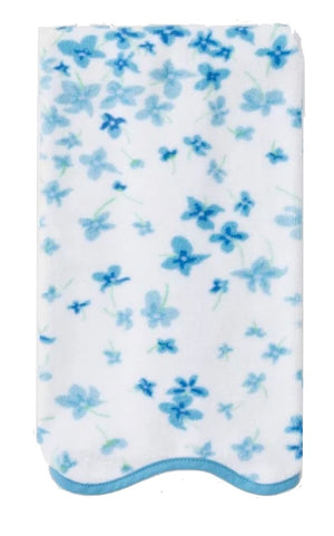 The folded white Betty Floral Scallop Bath Towel from Weezie Towels features a blue floral motif and scalloped trim, combining elegance and luxury in every detail.