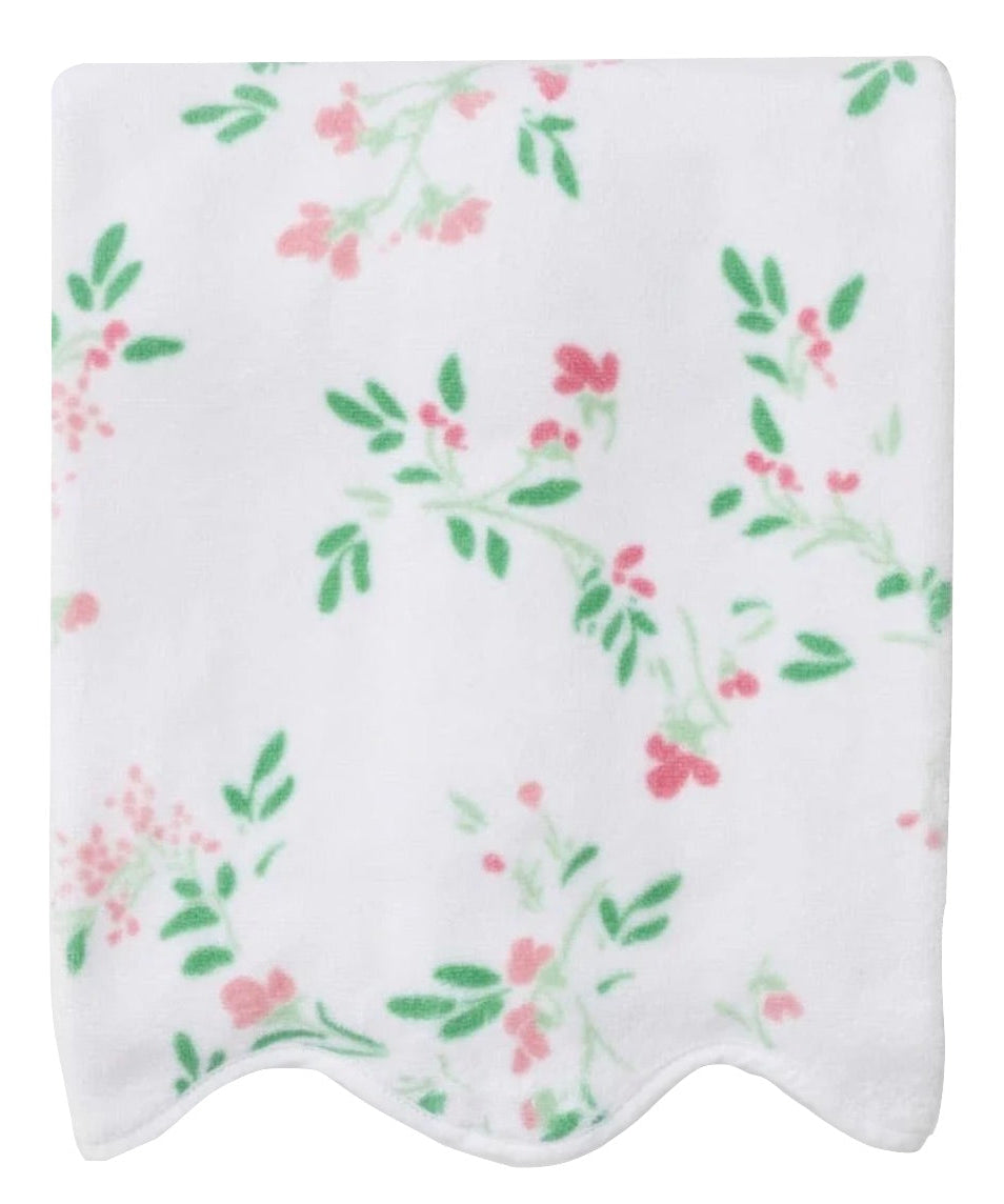 A white towel from Weezie Towels' Alice Floral Scallop Collection, featuring hand-finished scallop trim with green leaves and pink flowers.