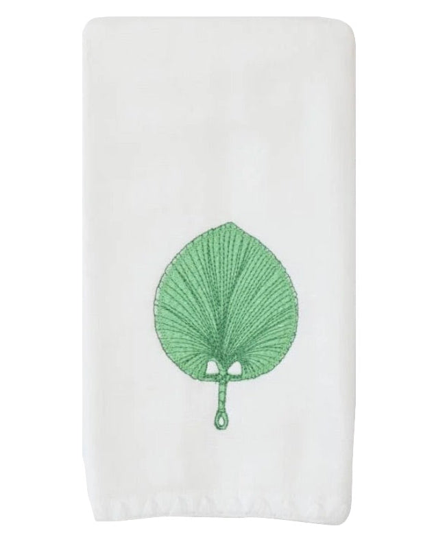 The Weezie x Meg Braff Fan Powder Bath Towel by Weezie Towels features a white design with an embroidered green leaf and a central handle, inspired by Meg Braff’s iconic Palm Beach style.