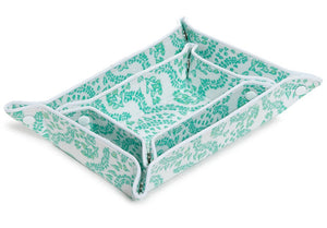 The Luxe Gloss Tray Set Collection by TRVL Design features a rectangular fabric tray with a green leaf pattern, snap button corners, and three compartments—ideal for organizing pocket items or using as a travel organizer.