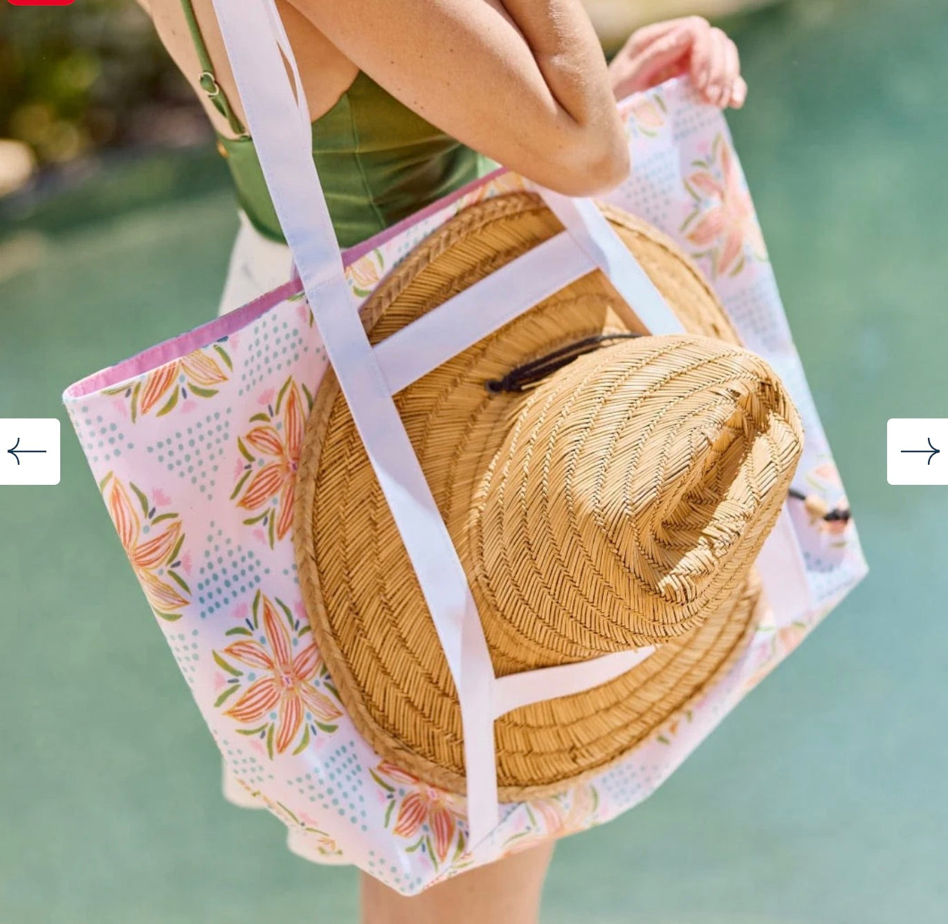 A person holds the Weezie x Lulie Wallace Beach Tote by Weezie Towels, featuring a colorful pattern and wipeable interior, while standing near a swimming pool.