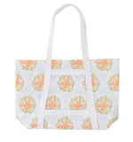 The Weezie x Lulie Wallace Beach Tote by Weezie Towels features long handles, a vibrant floral print with green leaves and blue dots, and a wipeable interior—ideal for easy cleaning after trips to the beach.