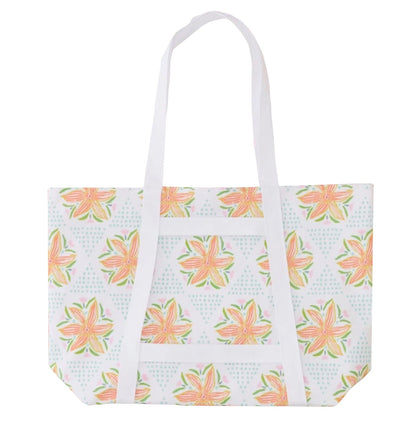 The Weezie x Lulie Wallace Beach Tote by Weezie Towels features long handles, a vibrant floral print with green leaves and blue dots, and a wipeable interior—ideal for easy cleaning after trips to the beach.