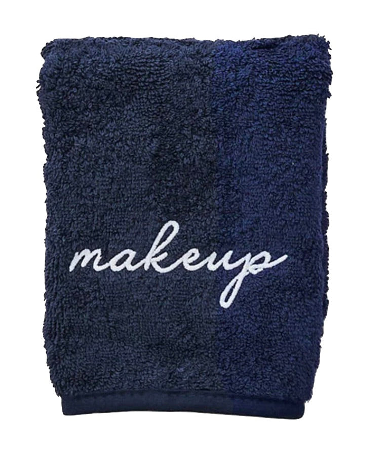 The Weezie Towels Makeup Towel is a navy terry towel embroidered with "makeup" in white script, offering a stylish and stain-resistant solution for your beauty routine.