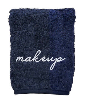 The Weezie Towels Makeup Towel is a navy terry towel embroidered with "makeup" in white script, offering a stylish and stain-resistant solution for your beauty routine.