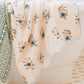 A towel from the Floral Scallop Cora Towel Collection by HIVE Home, Gift and Garden hangs over the bathtub next to a green and white towel, adding a touch of luxury to your bathroom.
