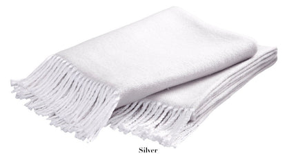 The Pezzo Throw Collection by Matouk features a folded, light silver cozy throw made of brushed cotton with fringed edges, displayed on a white background.