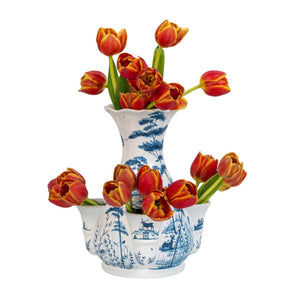 The Juliska JUL Country Estate Tulipiere Vase, 11.5", in Delft Blue, features painted landscape designs and comes filled with red and yellow tulips, isolated on a white background.