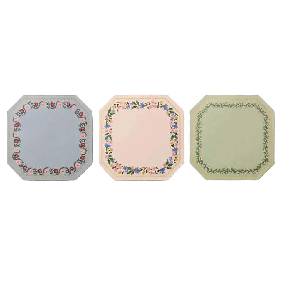 The Rifle Paper Co. Gemma Mini Notepad Trio includes three octagonal notepads, each with a unique floral border and gold accents in blue, cream, and green designs.