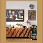 Featuring “Beata Heuman, Every Room Should Sing” by Rizzoli, this space showcases a wooden sideboard with a zebra pattern adorned with flowers and a lamp, infusing the room with Scandinavian flair; vibrant art and photos hang above, beside an upholstered floral chair thoughtfully arranged by an interior designer.