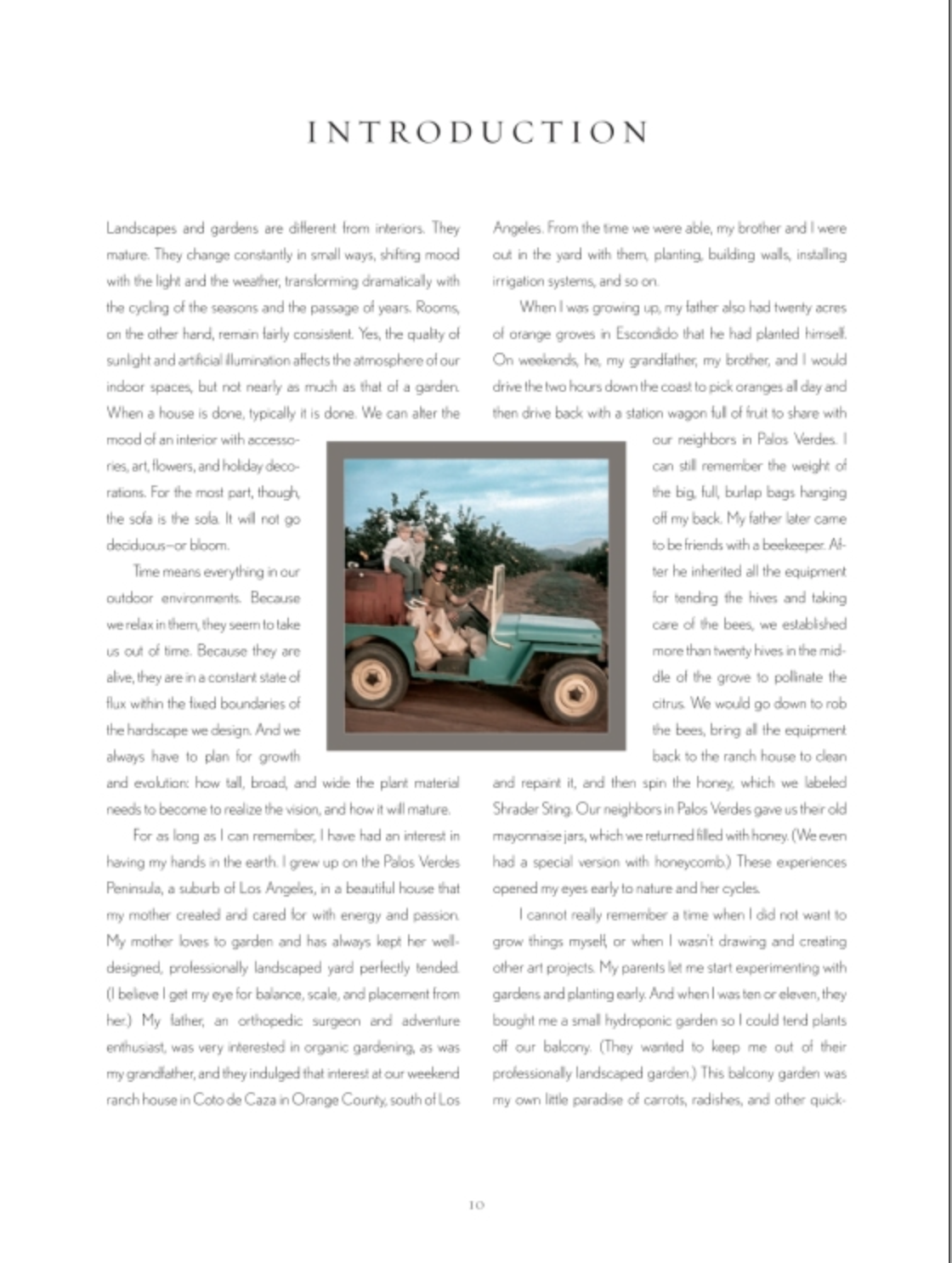 A person sits on the back of an old beige pickup truck filled with crates and plants, parked outdoors in a rural setting surrounded by trees and a fence—a scene reminiscent of the inspiring imagery featured in *The Art of Outdoor Living* by Rizzoli.