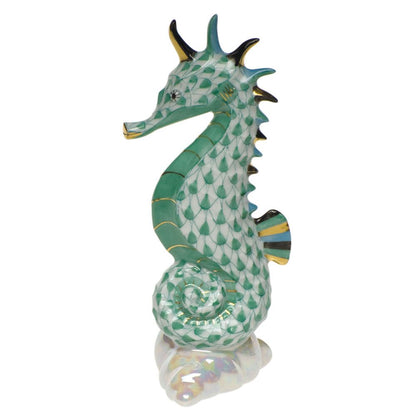 Herend’s Sea Horse features a hand-painted green fishnet pattern, gold accents, and a curled tail—showcasing the brand’s porcelain artistry in an elegant figurine.