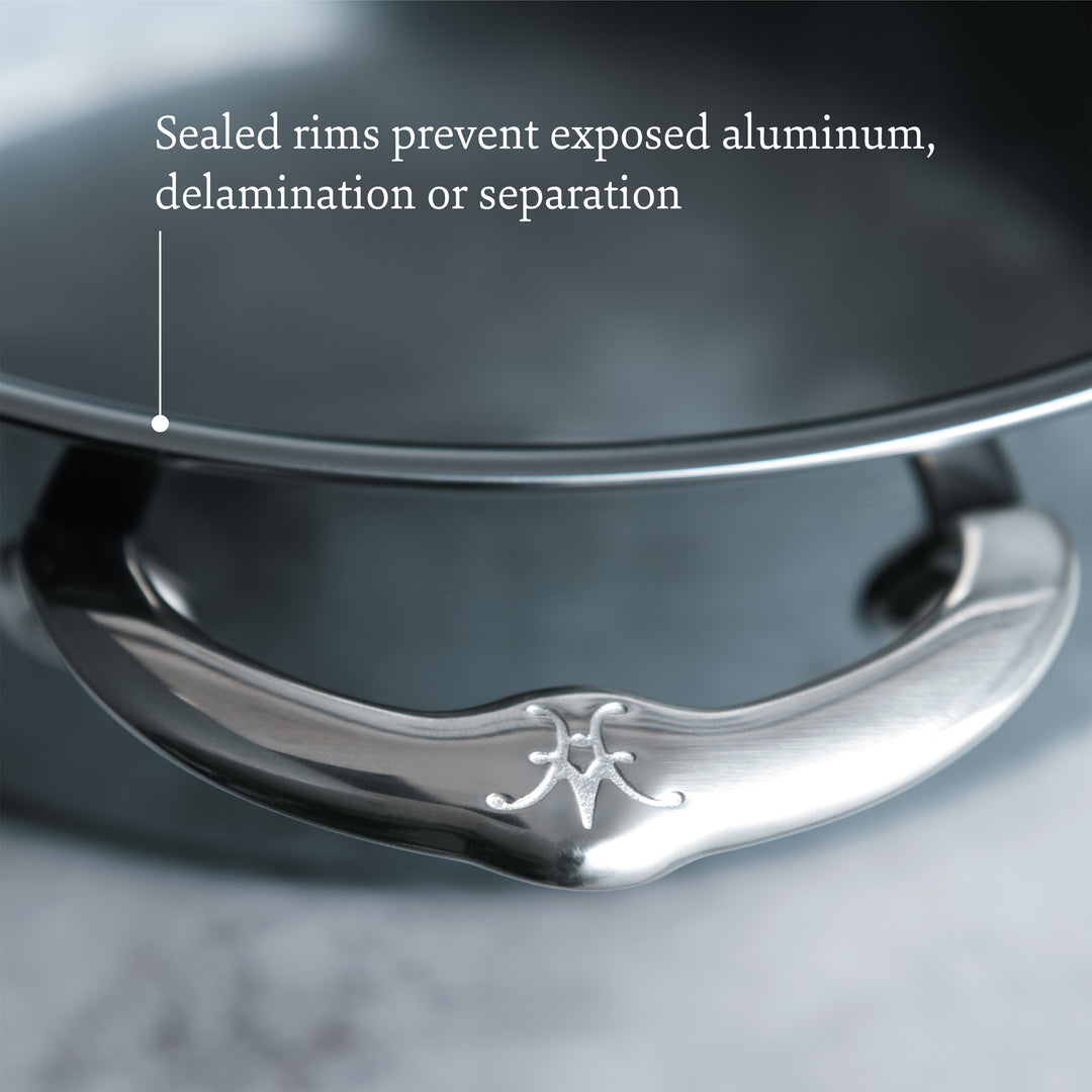 Close-up of a Hestan NanoBond Titanium Ultimate Cookware 10-Piece Set handle with engraved logo, showcasing the sealed rim and ProCore aluminum core that prevent exposed aluminum, delamination, or separation.
