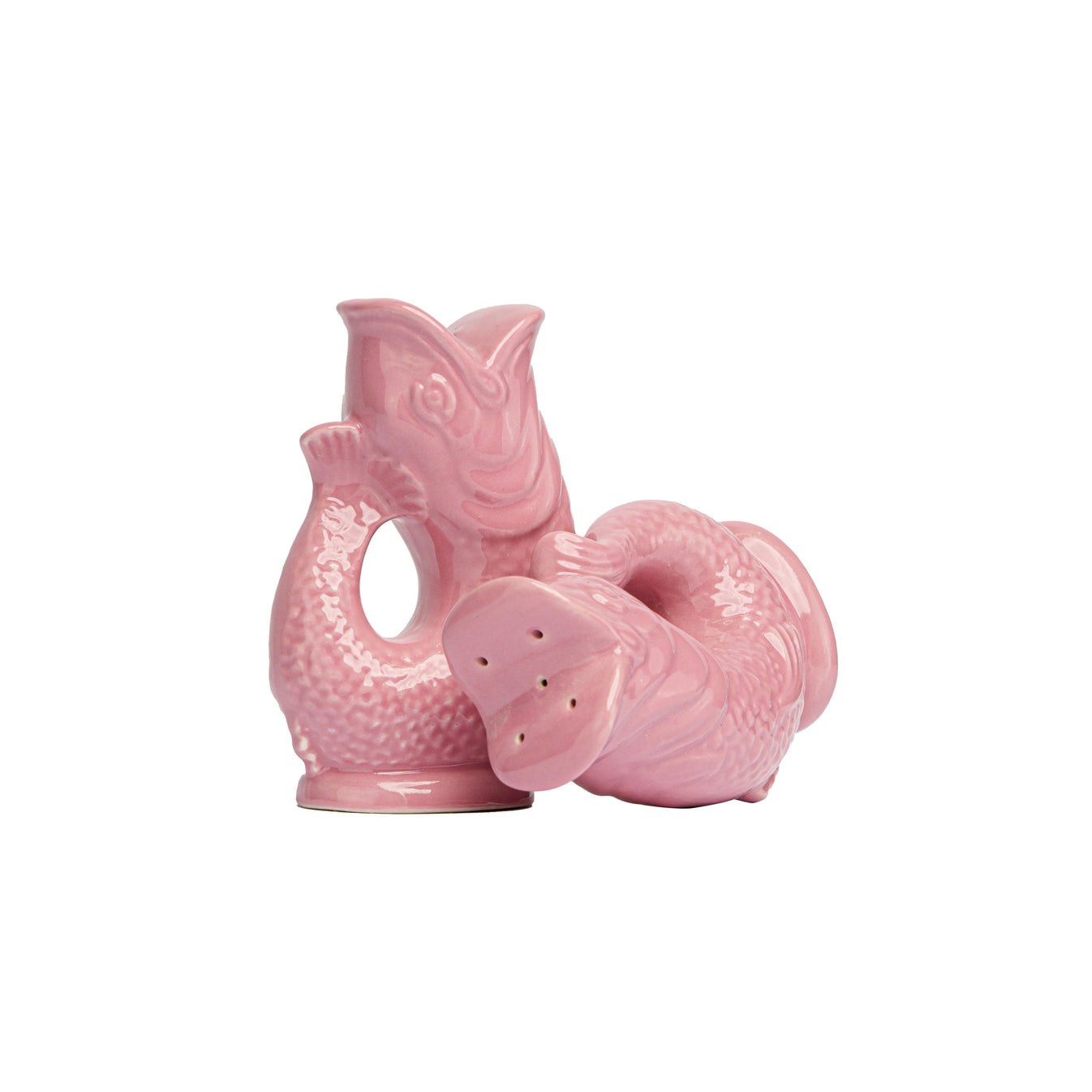 The Original Gluggle Jug Fish Salt & Pepper Shakers are displayed—one upright, one on its side revealing the holes—crafted in pink ceramic and echoing the iconic miniature Gluggle Jug design.