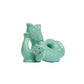 The Original Gluggle Jug's Fish Salt & Pepper Shakers feature two turquoise ceramic fish—one upright, one on its side—with bottom holes for shaking, inspired by the classic jug design.