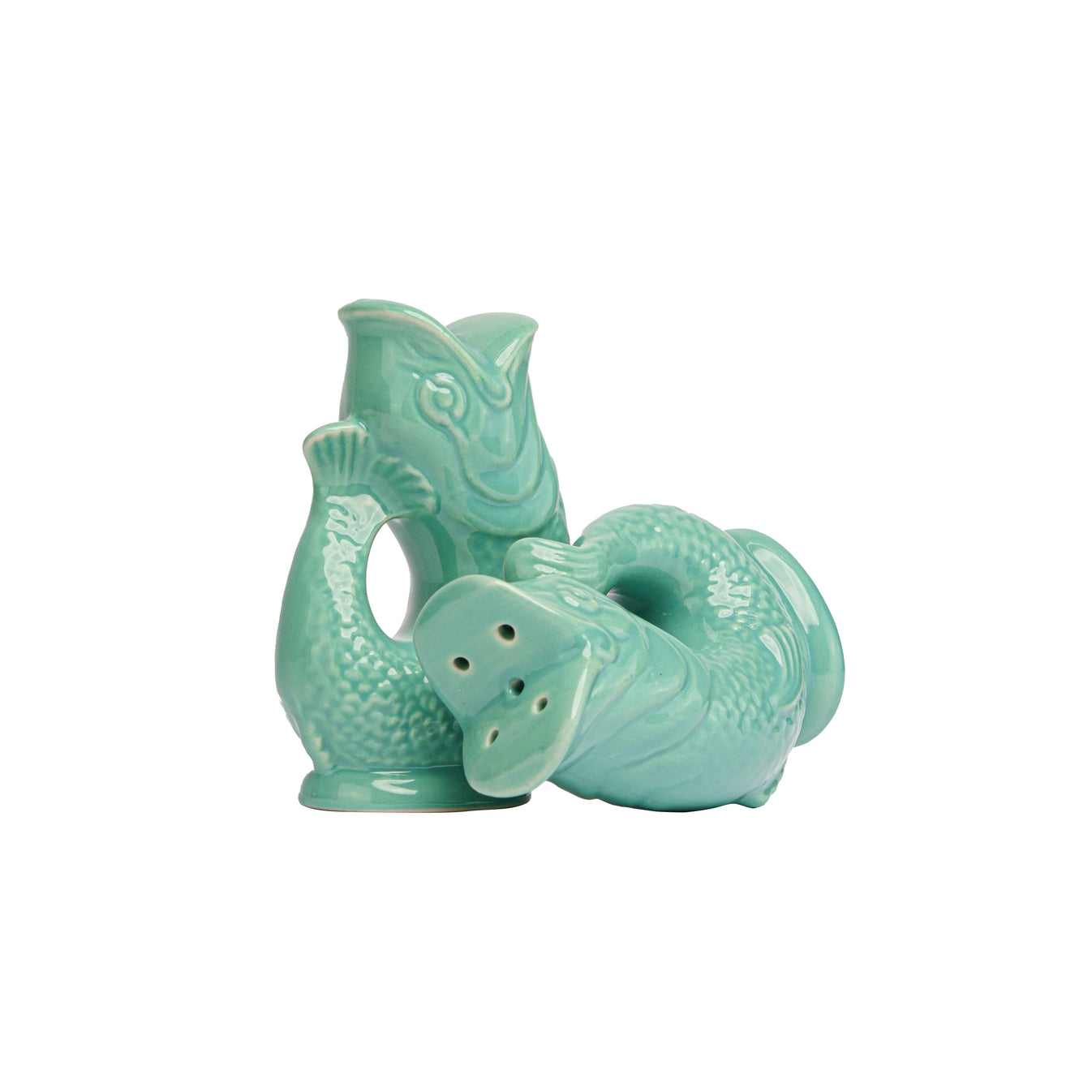 The Original Gluggle Jug's Fish Salt & Pepper Shakers feature two turquoise ceramic fish—one upright, one on its side—with bottom holes for shaking, inspired by the classic jug design.