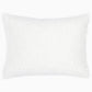 A white rectangular pillow from the John Robshaw Hand-Stitched Bedding Collection, featuring a textured woven pattern and stitched edges, is photographed against a plain white background, evoking the look of an organic cotton coverlet.