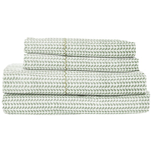 The John Robshaw Cinde Sage Bedding Collection features neatly folded green and white leaf-patterned cotton percale sheets and pillowcases in the charming Cinde print.