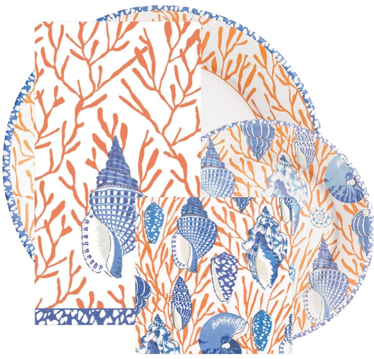 Caspari’s Shell Toile Collection features plates and napkins with orange coral and blue seashell patterns, layered and overlapping—ideal for stylish entertaining or gifting.