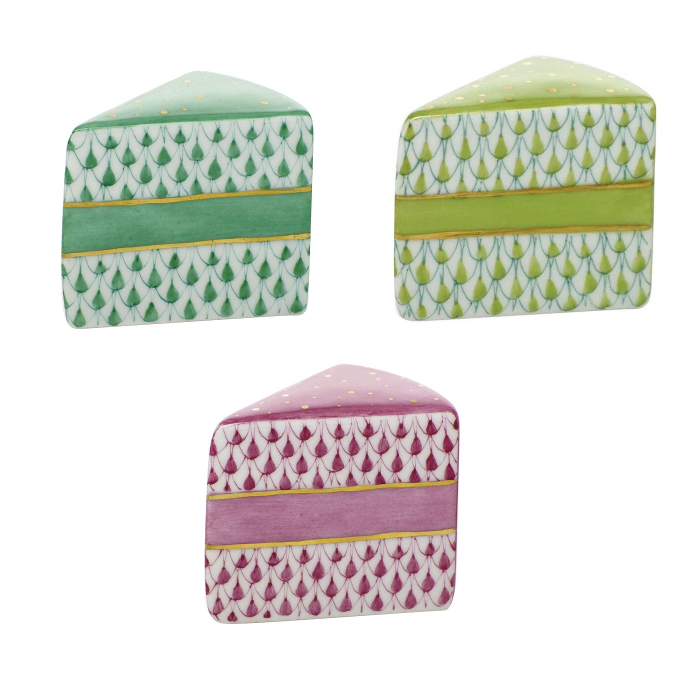 The "Slice of Cake" ceramics by Herend feature hand-painted designs in green, yellow-green, and pink, showcasing intricate patterns reminiscent of classic Herend porcelain.
