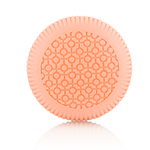 A round, light orange item with a patterned surface and ridged edges from Baobab Collection Women Body Wellness Collection by Baobab, shown on a white background, evoking the softness of a women’s floral fragrance.