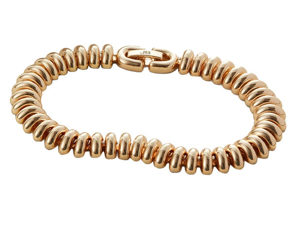 A gold-tone dipped bracelet with a series of linked, rounded beads and a high polish finish, featuring a foldover clasp engraved with the initials "JB," the Jenny Bird Sofia Bracelet 6" by Jenny Bird.