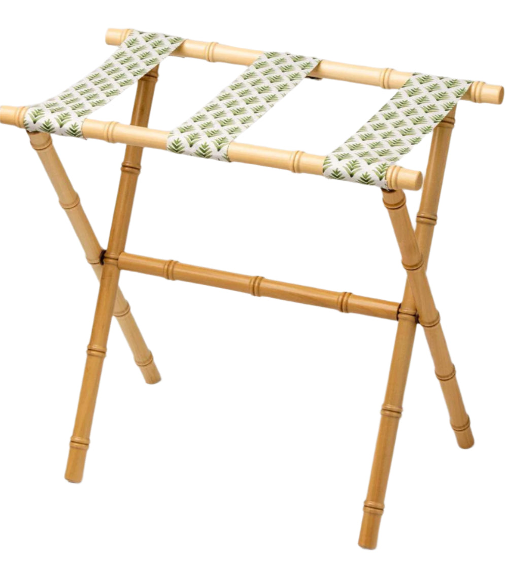 The Sorella Glenn Maple Luggage Rack, Highlands Pine, features three sturdy fabric straps with a green leaf pattern—perfect for stylish suitcase storage.