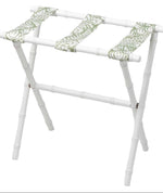 The Sorella Glenn White Luggage Rack, Fern Moss, features maple hardwood construction and green-patterned fabric straps for convenient suitcase storage.