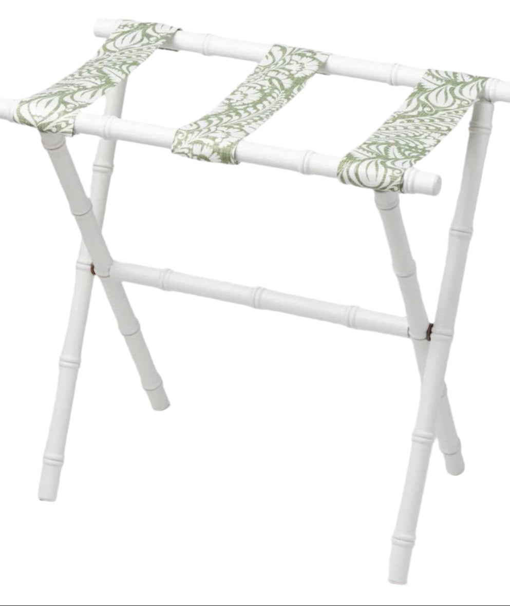 The Sorella Glenn White Luggage Rack, Fern Moss, features maple hardwood construction and green-patterned fabric straps for convenient suitcase storage.