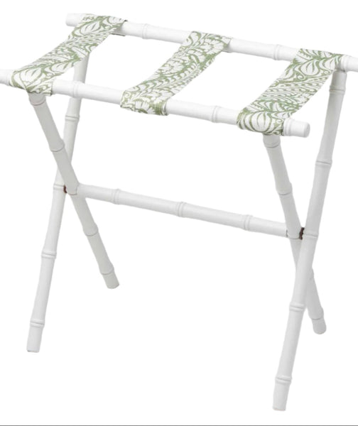 The Sorella Glenn White Luggage Rack, Fern Moss by Sorella Glenn features a maple hardwood frame and green and white patterned fabric straps for convenient suitcase storage.