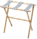 The Sorella Glenn Maple Luggage Rack, Highlands Indigo, features sturdy maple hardwood with bamboo-style legs and three fabric straps in a blue leaf pattern—perfect for convenient suitcase storage.