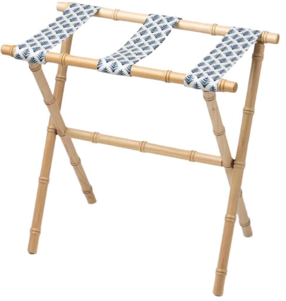 The Sorella Glenn Maple Luggage Rack, Highlands Indigo, features sturdy maple hardwood with bamboo-style legs and three fabric straps in a blue leaf pattern—perfect for convenient suitcase storage.