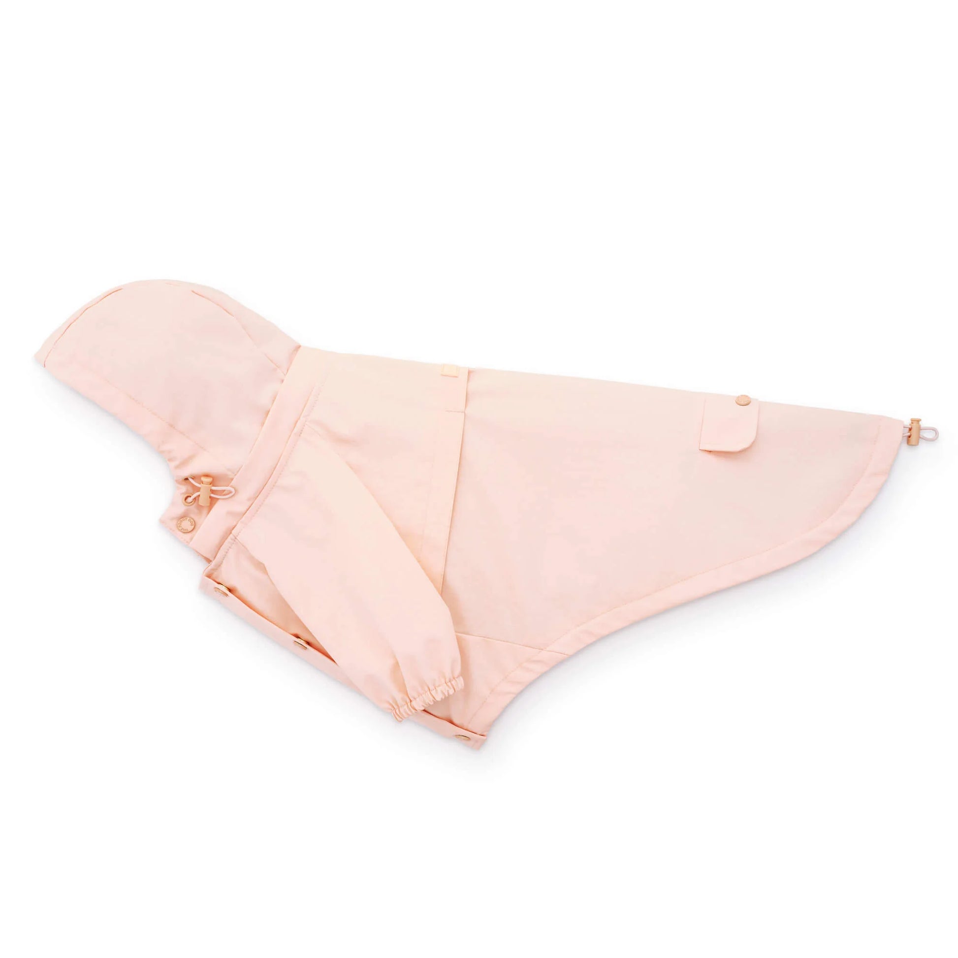 The Foggy Dog's light pink Dog Raincoat, featuring a waterproof design, pocket, hood, and adjustable drawstrings, is laid flat on a white background.