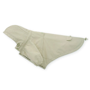 The Foggy Dog's Dog Raincoat is a beige, waterproof, lightweight jacket with adjustable drawstrings, a back pocket, removable hood, and leash opening.