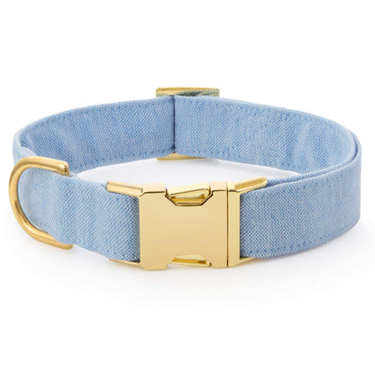 The Foggy Dog Blue Chambray Dog Collar features light blue chambray fabric, a gold metal buckle and D-ring for style and comfort, shown on a white background.