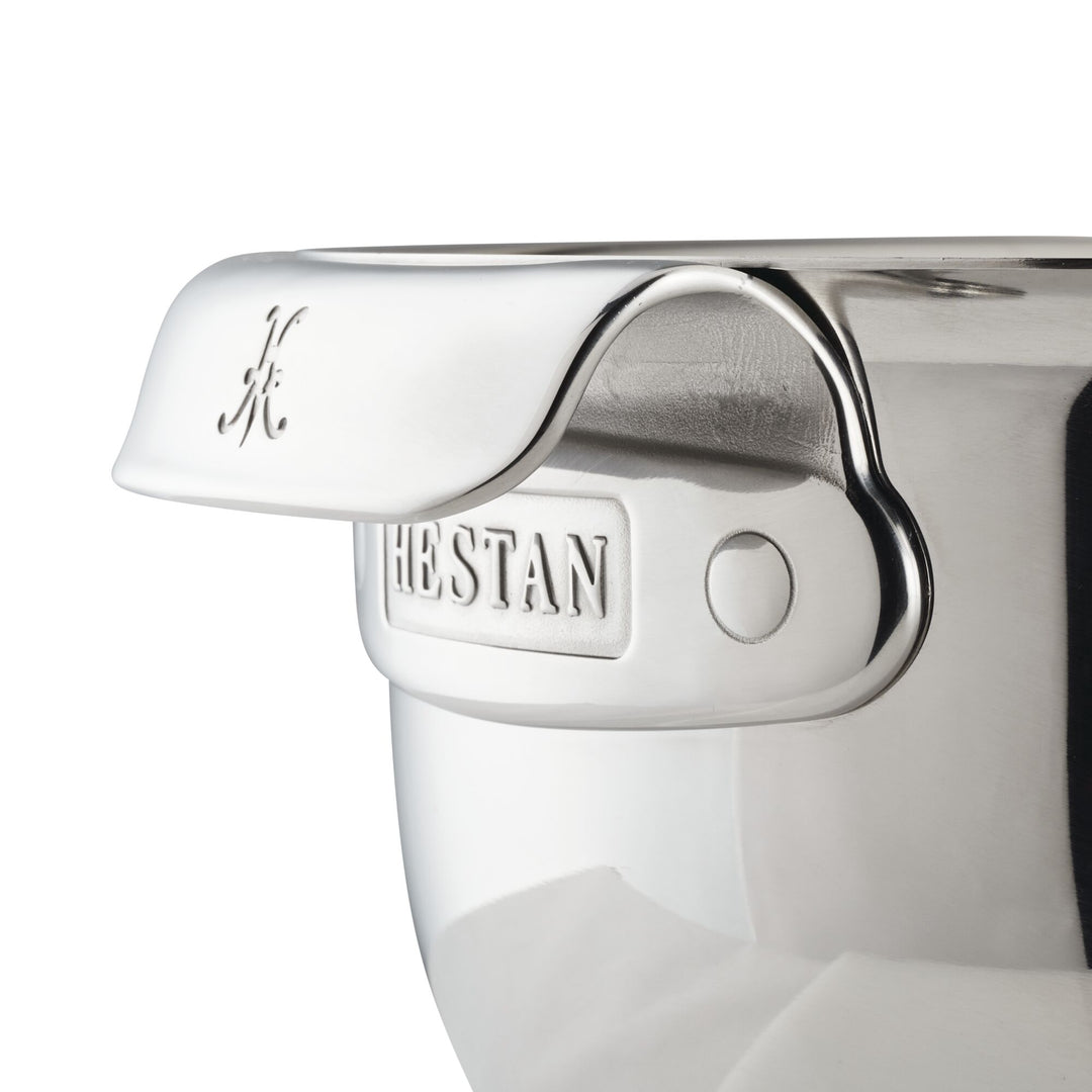 Close-up of a Hestan Provisions Stainless Steel Mixing Bowl 3-Piece Set, highlighting the branded ergonomic handle and polished rim against a white background.