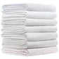 A neatly stacked pile of six folded, white quilted blankets with subtle colored stitching is arranged against a plain white background—a perfect showcase for the John Robshaw Hand-Stitched Bedding Collection, crafted from airy organic cotton voile and finished with delicate hand-stitched detailing.