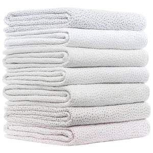 A neatly stacked pile of six folded, white quilted blankets with subtle colored stitching is arranged against a plain white background—a perfect showcase for the John Robshaw Hand-Stitched Bedding Collection, crafted from airy organic cotton voile and finished with delicate hand-stitched detailing.