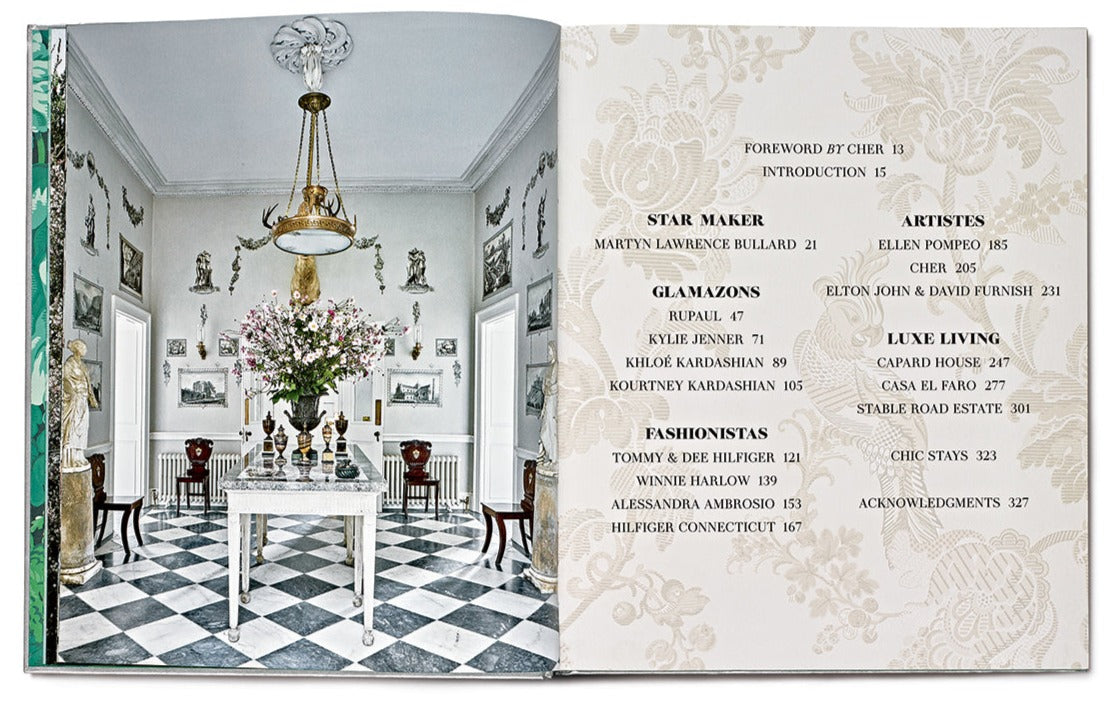 An open book, "Star Style: Interiors of Martyn Lawrence Bullard" by Vendome, showcasing on the left side a room with a black and white checkered floor, a round table with a floral centerpiece, and ornate decorations reminiscent of eclectic interiors; on the right, a table of contents listing various sections.