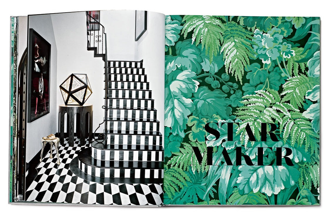 Open book showing a black and white staircase on the left page and a green leafy pattern with the words "Star Style: Interiors of Martyn Lawrence Bullard" on the right page, reminiscent of Vendome's eclectic interiors.