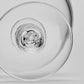 Close-up view of the circular base of a Simon Pearce Stratton Bowl, featuring a clear glass, textured, indented center.