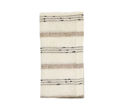 Folded Stria Ivory & Black Napkin featuring horizontal tan stripes and black dashed detailing.