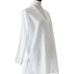 The Sue Nightshirt by Haute Home is a white, long-sleeve button-up blouse in smooth cotton sateen with a curved collar and side slits, shown on a dress form—an elegant choice for luxury sleepwear.