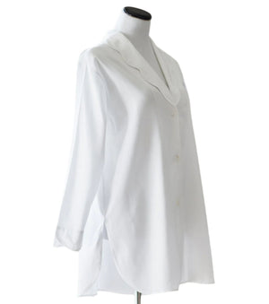 The Sue Nightshirt by Haute Home is a white, long-sleeve button-up blouse in smooth cotton sateen with a curved collar and side slits, shown on a dress form—an elegant choice for luxury sleepwear.