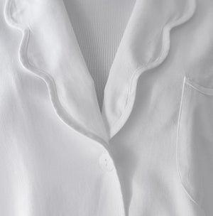 Close-up of the Sue Nightshirt by Haute Home in cotton sateen, with wavy collar, single white button, chest pocket, and ribbed white undershirt—a touch of refined comfort in elegant sleepwear.